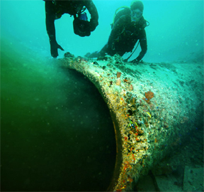An image from the series showing divers sampling partially treated sewage flowing unimpeded off the coast of Florida